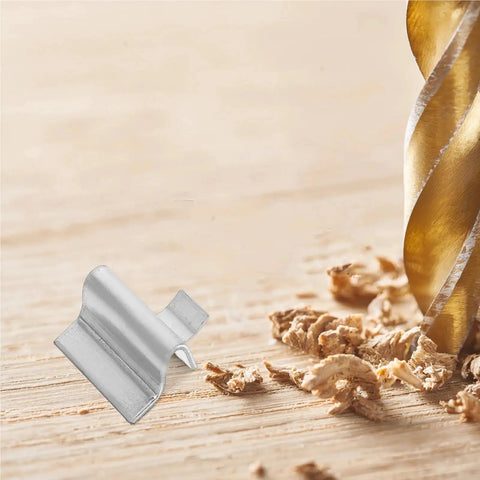 Close-up of Partition Buckle Shelf Clips for Cabinet Installation Support next to wood shavings and drill bit.