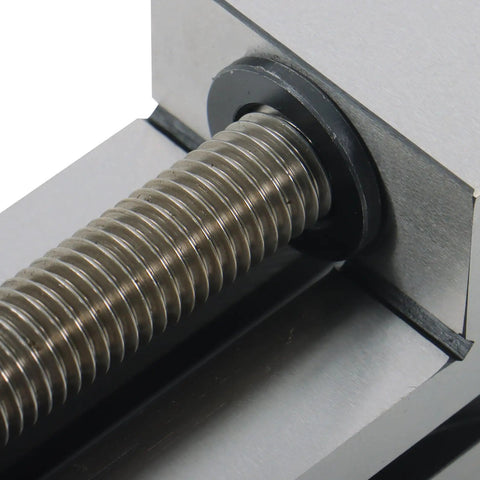 Close-up of Versatile QGG50 Surface Grinder Toolmaker Vise With Integrated V-Grooves showing threaded screw mechanism for CNC workholding.