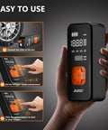 Person holding Portable Tire Inflator Air Pump With Digital Pressure Gauge And LED Light, 4X Faster Inflation To 150 PSI
