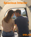 Two Person No Fuss Instant Camping Tent With 60 Second Setup, inner view with mesh ventilation, couple sitting inside.