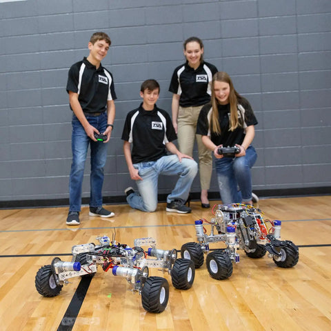 Students control robots fitted with "All Terrain Tire Kit For TETRIX MAX Robotics, Monster Truck Style Wheels With Foam Inserts"