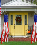 Pair Of 60 Inch American Flag Windsocks With Red White Blue LED Lights For Outdoors Patriotic Fourth Of July Memorial Day Decor 250th Anniversary USA Windsocks Festive Outdoor Display hanging outside a house.