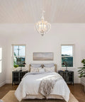 Farmhouse 5 Light French Country Wood Chandelier For Dining Room And Kitchen Island hanging over a rustic bedroom.