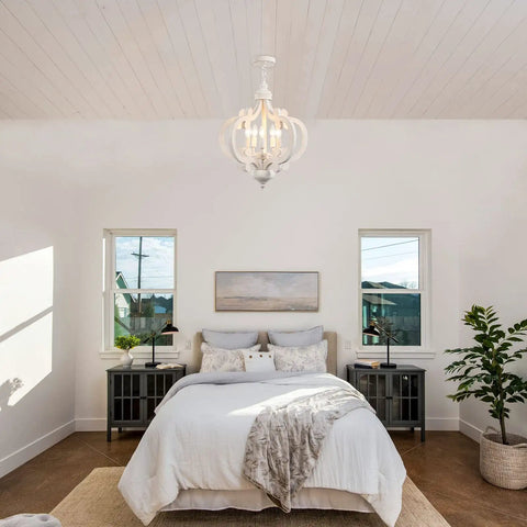Farmhouse 5 Light French Country Wood Chandelier For Dining Room And Kitchen Island hanging over a rustic bedroom.