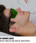 Person wearing Laser Safety Glasses For IPL 200 To 2000 Nm Eye Protection with green lens during laser treatment