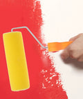 Textured Sponge Paint Roller For Wall Painting With Ergonomic Handle applying yellow sponge roller on red wall.