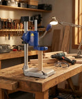 Drill Press Stand with Adjustable Depth Control and Vertical Support in workshop, featuring sturdy aluminum base and hand drill mount.