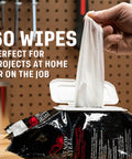 Grimy Scrub Workshop Wipes With Scrubbing Beads For Grease Grime Oil Paint And Caulk, pack of 60 wipes shown on workbench