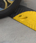 Car rolling over Eco XPT Speed Bump Kit With Cable Channel For Private Roads And Parking Lots Heavy Duty Plastic Rubber