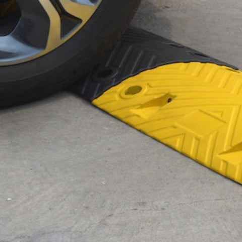 Car rolling over Eco XPT Speed Bump Kit With Cable Channel For Private Roads And Parking Lots Heavy Duty Plastic Rubber