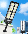 Outdoor Waterproof 6500K LED Motion Light With Remote Control, mounted on a wall, showing solar panel, lights, and remote control.