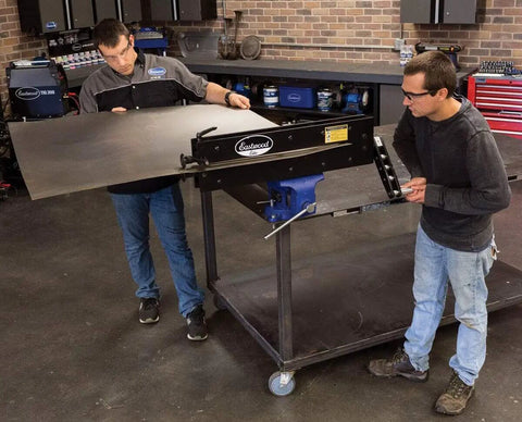 Two people using Elite Bead Roller With 27 Inch Throat Capacity For Floor Pans Firewalls Trunk Floors And Inner Fenders.