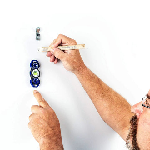 Man using Magnetic Stud Finder Leveler With Built In Hang Hole Dual Level And Plumb Helper for hanging on wall