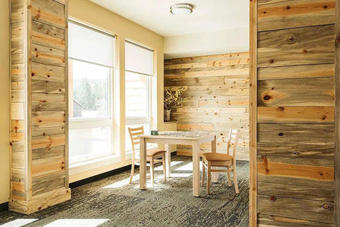 Vinyl Wall Base 4 Inch By 40 Foot Peel And Stick Baseboard Trim in modern room with wooden walls and table.