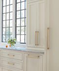 Lintel 18 Inch Center To Center Champagne Bronze Appliance Pull on large white cabinets in kitchen