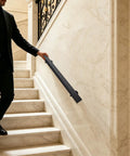 Tough As Nails Flush Wall Mount Handrail Made From Premium Stainless Steel for secure indoor steps, black finish, installed beside marble stairs.