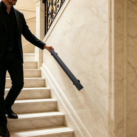 Tough As Nails Flush Wall Mount Handrail Made From Premium Stainless Steel for secure indoor steps, black finish, installed beside marble stairs.