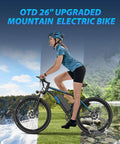 Woman riding All Terrain Electric Mountain Bike For Adults 1200W Peak Power Beast 28 MPH Top Speed 26 By 2.1 Inch Tires