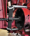 Heavy Duty 20 Inch Two Jaw Gear Puller Badass Chrome Vanadium Bearing Extractor positioned on a rusted brake drum.