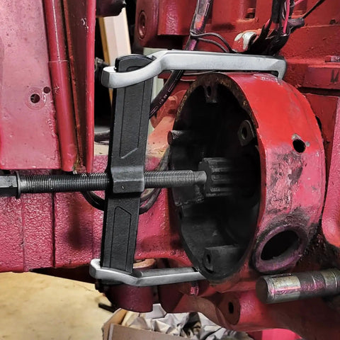 Heavy Duty 20 Inch Two Jaw Gear Puller Badass Chrome Vanadium Bearing Extractor positioned on a rusted brake drum.