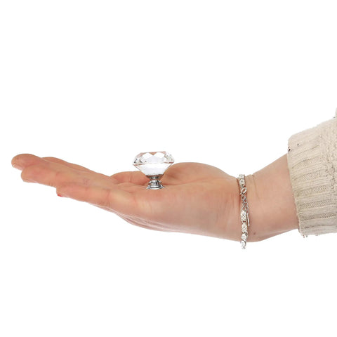 Hand holding a 26 Pack Crystal Clear Glass Cabinet Knobs Diamond Cut Drawer Pulls One And A Quarter Inch Diamond, Three Quarter Inch Base.