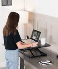 Ultra Slim Single Top Standing Desk Riser Height Adjustable Sit Stand Converter in use by person with laptop