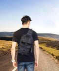Rugged Tactical Sling Bag Pack Waterproof Rucksack For Travel Hiking Camping Trekking Exploring Fishing Hunting shown outdoors