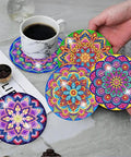Mandala Diamond Painting Coaster Kit With Holder For Dope DIY Beginners And Adults Art Coasters Cork Wood Pad Board Double Layer Strong And Wear Resistant Gift 4X4In displayed with colorful designs and coffee cup.