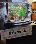 Fish tank with plants and blue fish; Colorful Dot Desk Nameplates Set 9.5x3 Inches For Kids Classrooms, 48 Pcs Confetti Watercolor Manuscript Name Plates.