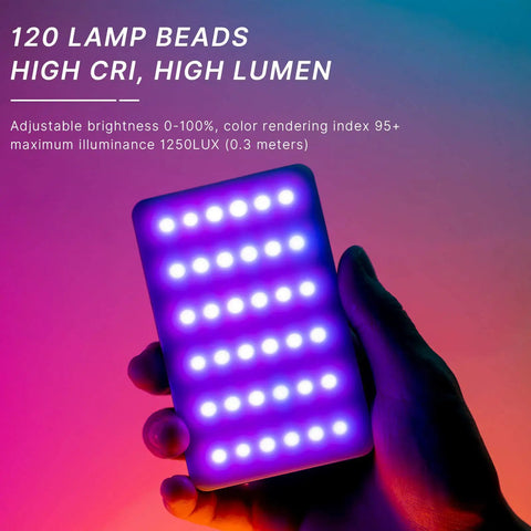Hand holding Portable RGB LED Video Light Panel for cameras, showing 120 LEDs glowing in purple, high CRI, rechargeable 3100mAh.