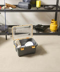 Toss Your Gear In This Heavy Duty 5.28 Gallon Waterproof Plastic Storage Tote Bin with open lid and contents in garage setting.