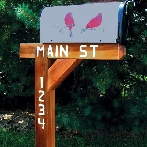 Wooden mailbox post with white stenciled street name and numbers, showcasing use of sign making router kit templates.