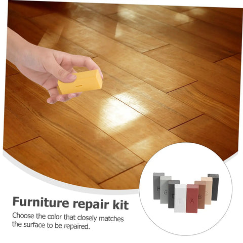 Hand using Floor And Tile Repair Wax Kit For Porcelain And Ceramic Tiles Quick Drying Hard Wax Filler on wood flooring