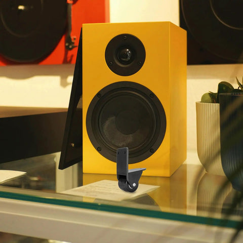 Rigid L Shape Plate Mount Casters for tool box next to a yellow speaker, heavy duty PVC rubber wheels