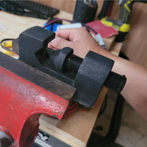 Three Point Mini Wire And Cable Crimper for Tight Spaces handheld crimp tool clamped in vise, used in small workshop setup