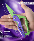 Hand holding Six In One Multitool Carabiner with folding knife and bottle opener, purple and green, dimensions shown