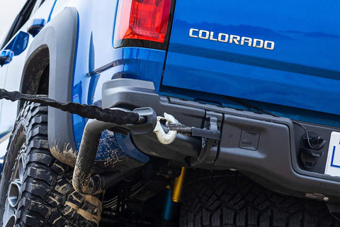 Tough As Nails 3/8 Inch By 12 Inch Soft Shackle With Heavy Duty Dyneema Fiber attached to a blue pickup truck for off-road recovery.