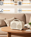 Stylish portable speaker on a wooden table in cozy living room setting, with text highlighting strong, durable, premium quality features.