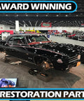 Award-winning restoration parts display with black vintage GTO car at auto show