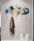 Sleek Wall Mounted Coat Rack With Extended Hook Arms For Entryway, wall decor with colorful leaf design and hanging scarf.