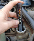 Person using Brake Fluid Tester Pen with 5 LED Indicators for DOT3 DOT4 DOT5.1 Testing in car engine bay for moisture check.