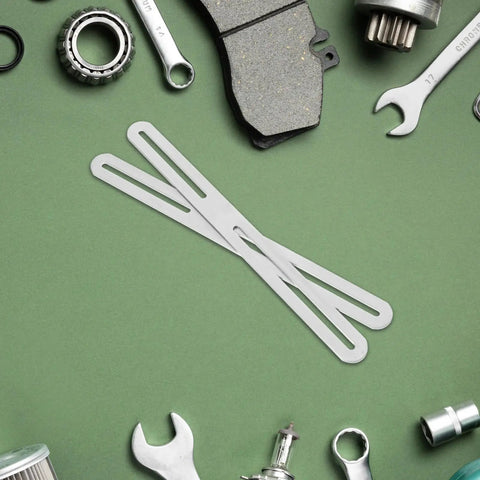 Stainless Steel Adjustable Flat Mending Plates With Sliding Screw Slots, 2 pack shown with tools on green surface