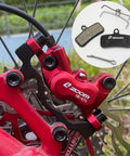 Two Pairs Four Piston Oil Semi Metal Bicycle Brake Pads For Zoom HB876 with red caliper installed on bike wheel