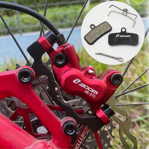 Two Pairs Four Piston Oil Semi Metal Bicycle Brake Pads For Zoom HB876 with red caliper installed on bike wheel