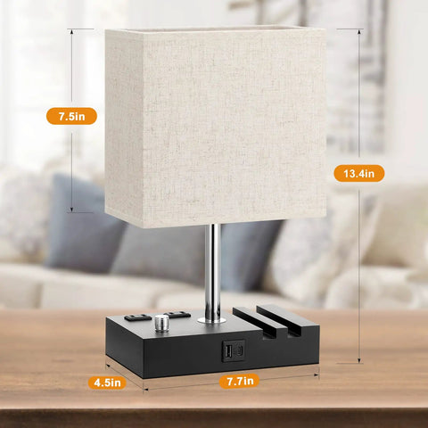 Set Of 2 Dimmable Beige Bedside Lamps With USB C Ports And Dual Charging Outlets shown on a wooden base with phone stand.