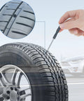 Hand using 30 Pcs Tire Repair Nails Self Tapping Screws Rubber Screws Self Service Tire Repair Kit on car tire with puncture detail