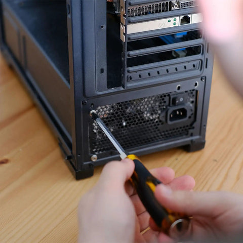 Installing Premium M5 X 12mm Phillips Flat Head Computer Case Fan Screws Kit into PC case for secure fit.