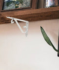 Heavy Duty Corner Shelf Brackets Wall Mount Supports Rock Solid Iron L Brackets Built Like A Tank For Diy Wood Shelving And Workshop Storage Super Sturdy Black Metal Braces Zero Stress Setup white corner bracket mounted on a rustic shelf