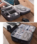 Three Layer Electronics Organizer Carry All Bag For Travel Gear Cable Organizer For iPad Mini Kindle Hard Drives Cables Chargers Grey Durable Nylon With Ample Pockets To Keep All Your Gadgets Neat And Ready showing cables and devices organized.