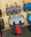 Premium Blue Aluminum Bench Vise With Sliding Screw And Brass Jaws For CNC Machining, Home Workshop Clamping, And Precise Mini Table Tool Work. Close-up of colorful vises on workbench.